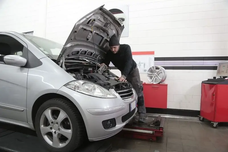 Man replacing automatic transmission