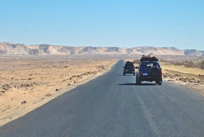 4x4s in desert on road